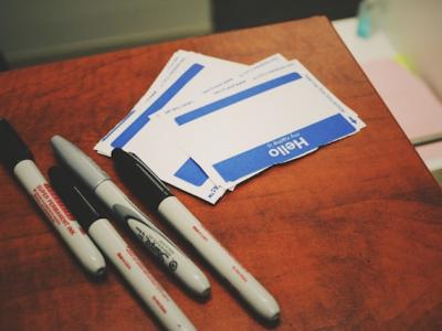 Markers and name stickers on a table.