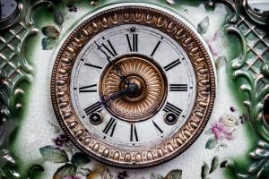 Clock with roman numerals and green and white background