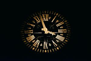 Round black and brown analog clock